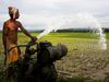 Photo: Man irrigating a field